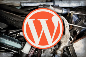 Orange WordPress logo over a cluttered junk drawer of tools, including screwdrivers and a hammer.